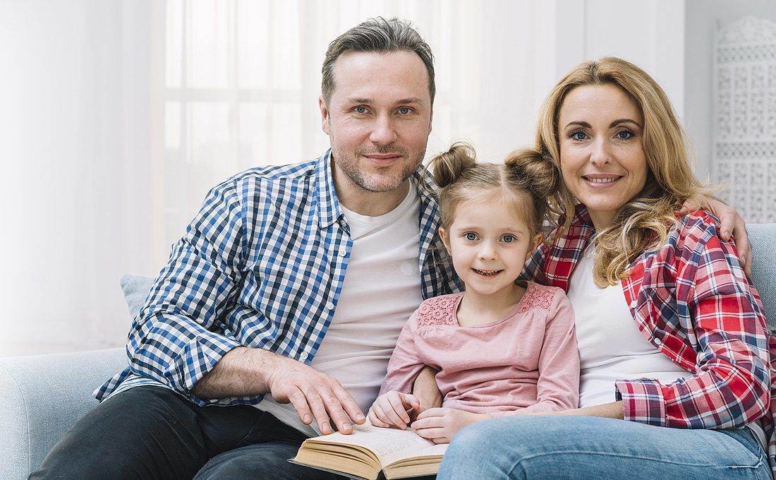 Family reading together at home – family life insurance Illinois