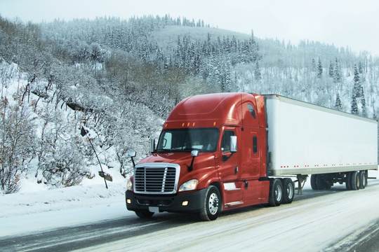 Semi truck driving in winter – commercial trucking insurance Illinois